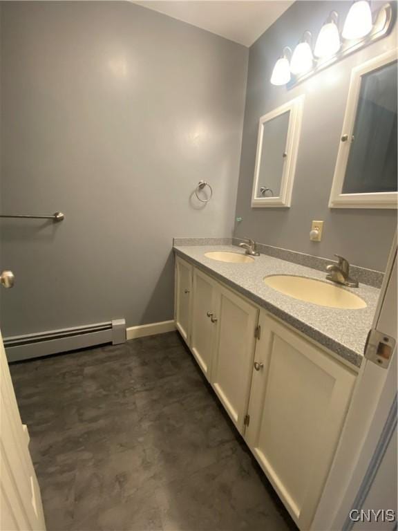 full bathroom with baseboards, a sink, baseboard heating, and double vanity