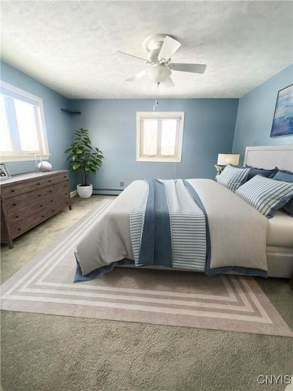 bedroom featuring ceiling fan, baseboard heating, and carpet