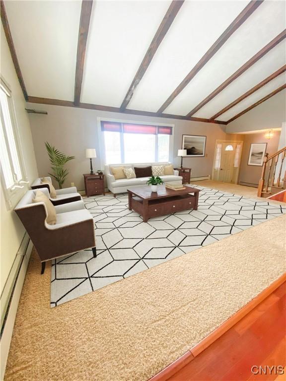 living room featuring vaulted ceiling with beams, stairs, and a baseboard heating unit