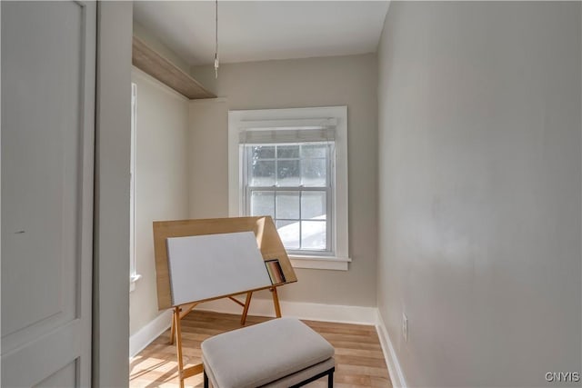 sitting room featuring light wood finished floors and baseboards