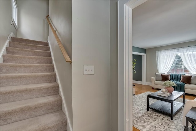 stairs with baseboards and wood finished floors