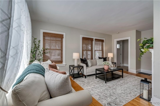 living area with wood finished floors and baseboards