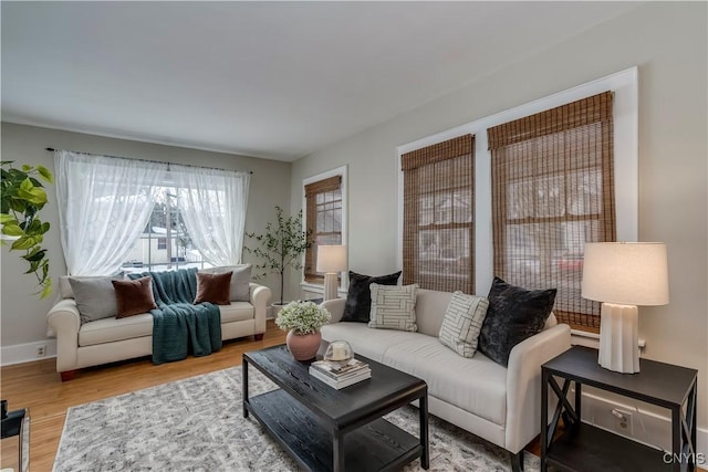 living area featuring baseboards and wood finished floors