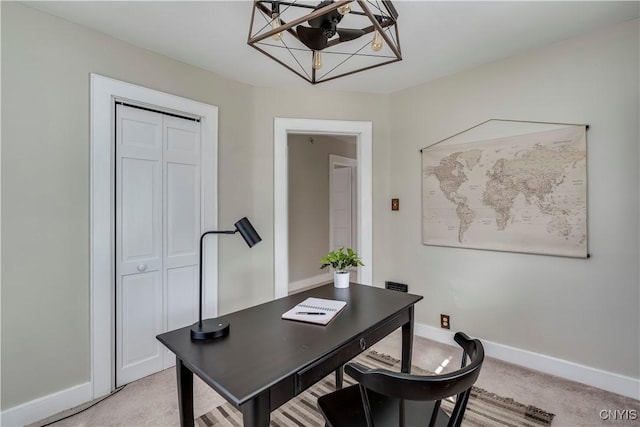 office featuring baseboards and light colored carpet