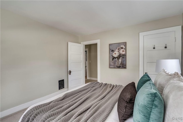 bedroom featuring light carpet, visible vents, and baseboards