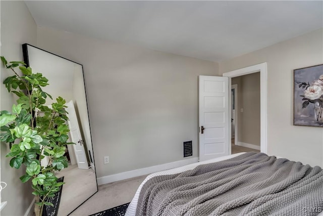 bedroom featuring carpet and baseboards