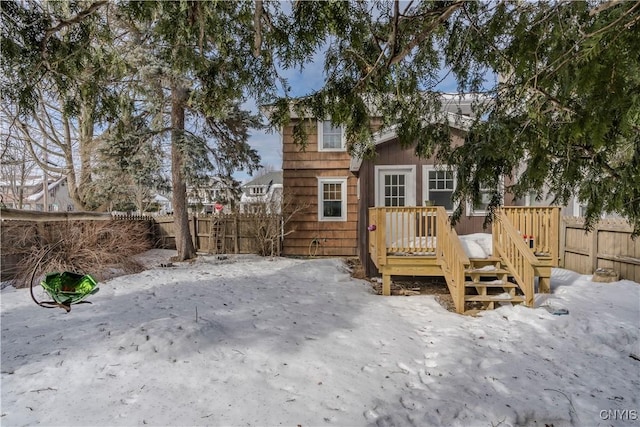 rear view of property featuring a deck and a fenced backyard