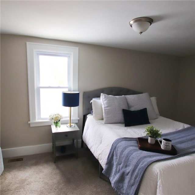 bedroom with visible vents, baseboards, and carpet flooring