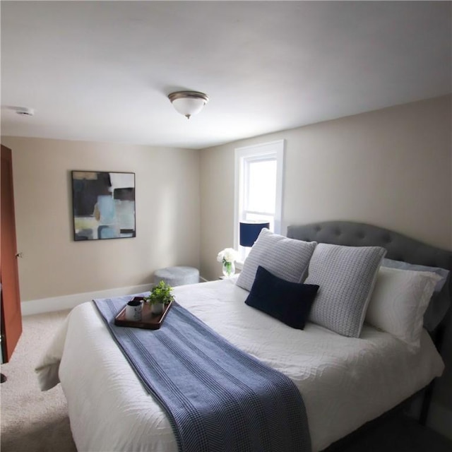 bedroom with carpet floors and baseboards