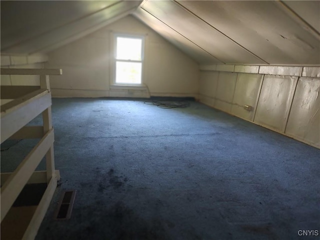 additional living space with lofted ceiling and carpet