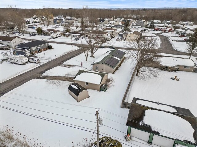 snowy aerial view with a residential view