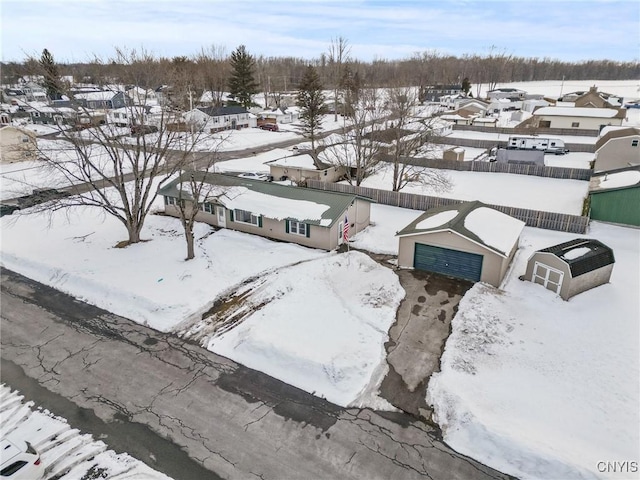 snowy aerial view featuring a residential view