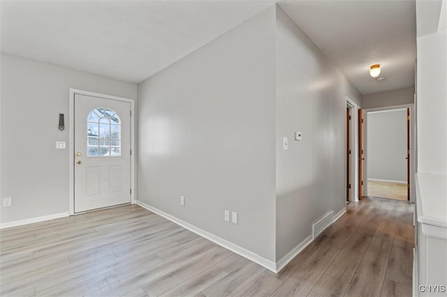 entrance foyer featuring light wood-style floors, visible vents, and baseboards