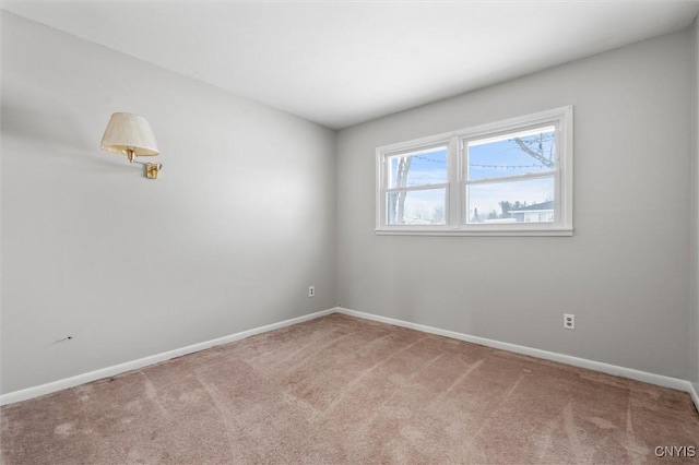 empty room with baseboards and carpet flooring