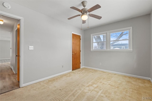 unfurnished bedroom featuring carpet, baseboards, and ceiling fan