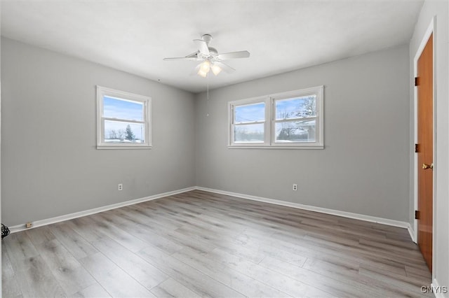 unfurnished room with a ceiling fan, baseboards, and wood finished floors