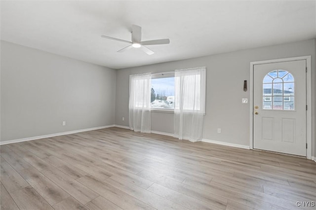 foyer entrance featuring light wood-style floors, a healthy amount of sunlight, and a ceiling fan