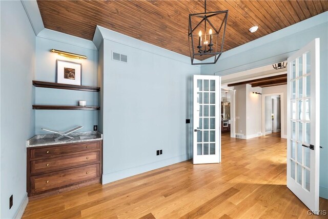 unfurnished room featuring french doors, visible vents, light wood-style flooring, wood ceiling, and baseboards