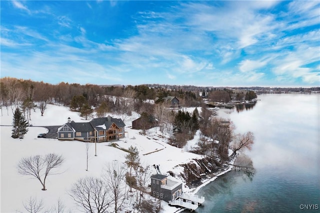 snowy aerial view with a water view