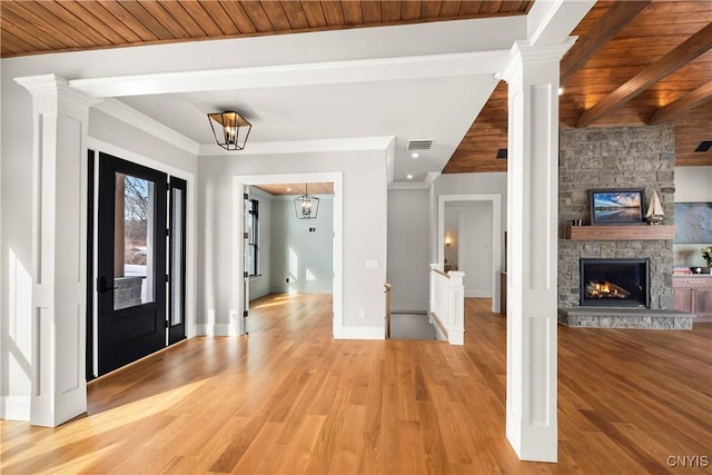 entryway with beam ceiling, visible vents, ornamental molding, wood ceiling, and light wood-type flooring