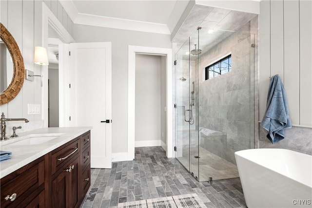 bathroom with ornamental molding, a freestanding tub, a shower stall, and vanity