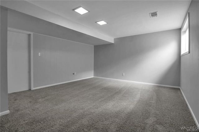 carpeted spare room with baseboards and visible vents