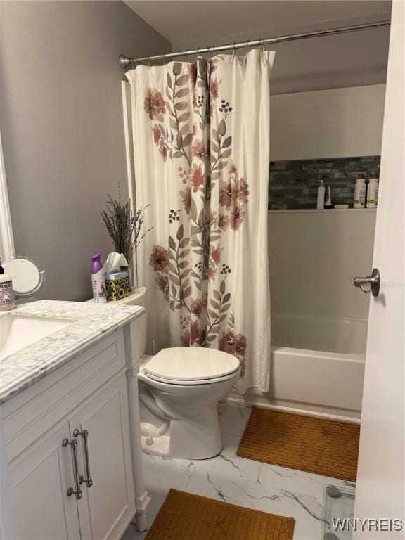 full bath with marble finish floor, shower / tub combo with curtain, vanity, and toilet