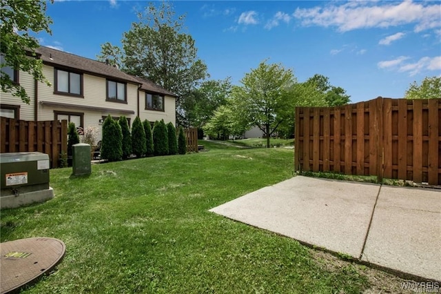 view of yard featuring fence and a patio