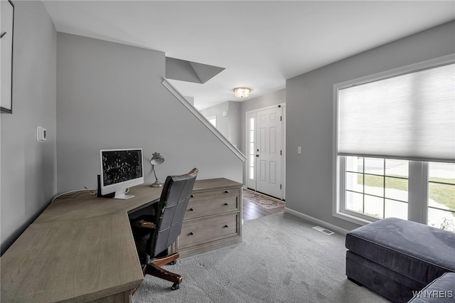 home office with carpet, visible vents, and baseboards