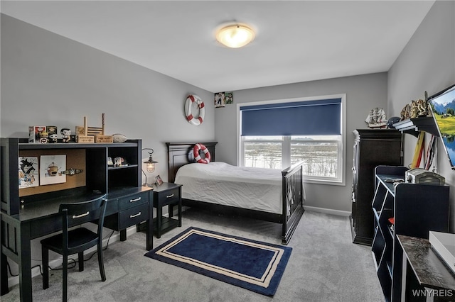 bedroom featuring carpet and baseboards