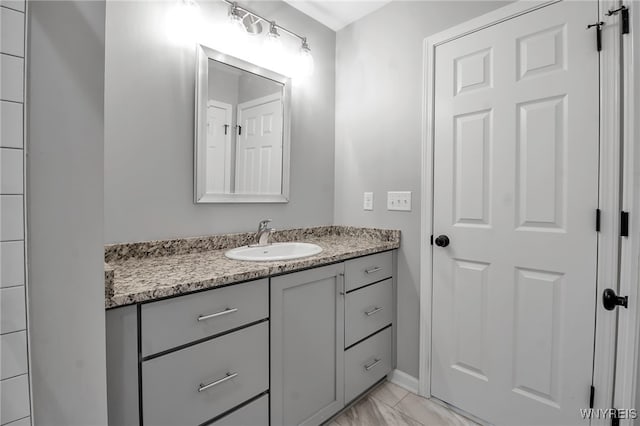 bathroom featuring marble finish floor and vanity