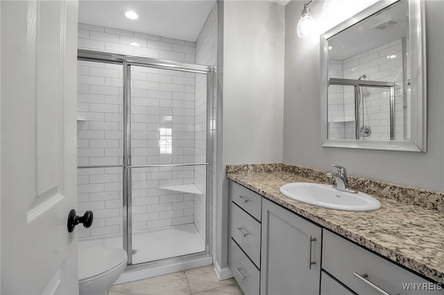 full bathroom with toilet, a shower stall, and vanity