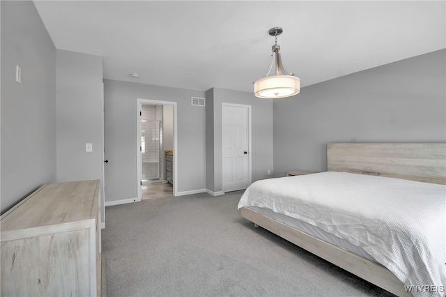 bedroom featuring baseboards, visible vents, ensuite bath, and carpet flooring