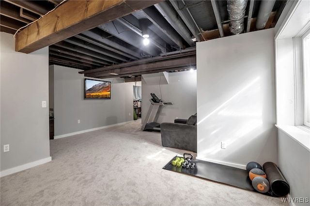 unfinished basement with carpet floors and baseboards