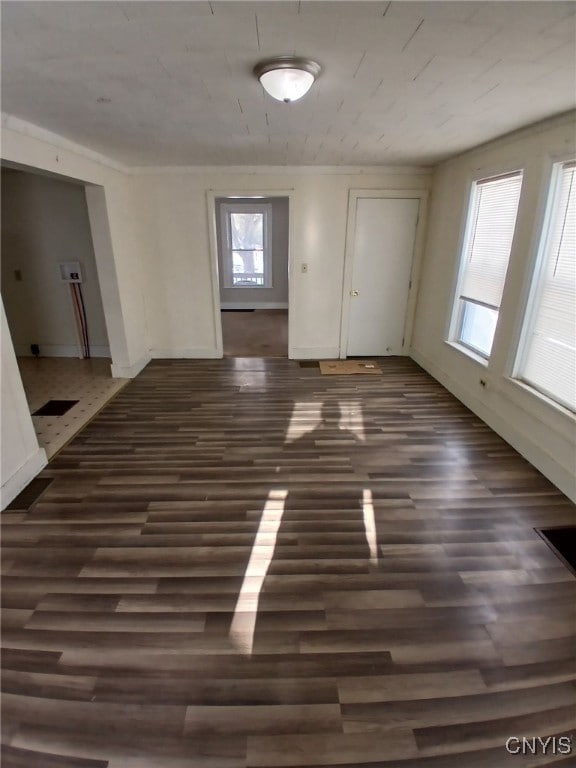 interior space featuring dark wood-type flooring and baseboards
