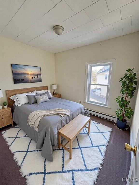 carpeted bedroom featuring a baseboard radiator