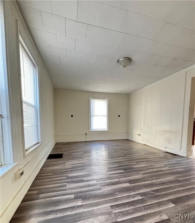 empty room featuring baseboards and wood finished floors