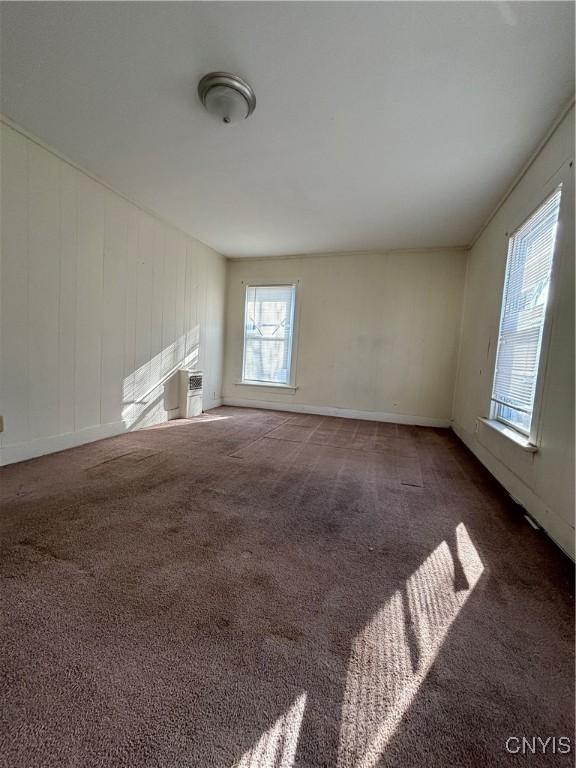 spare room featuring baseboards and carpet