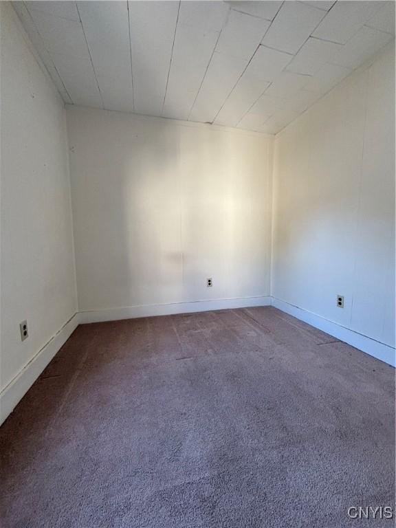carpeted empty room with baseboards