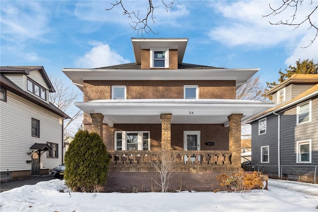 american foursquare style home featuring covered porch