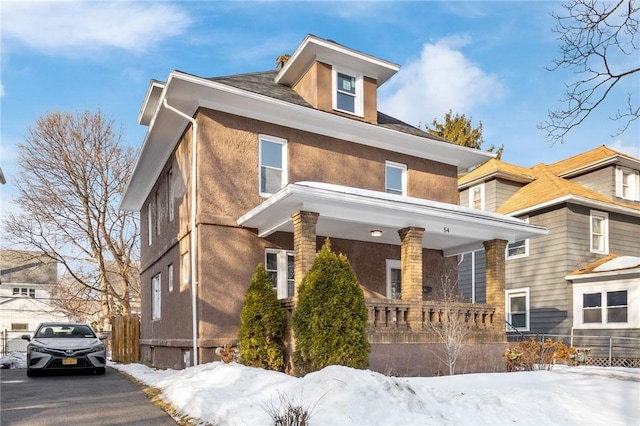 traditional style home with fence and stucco siding