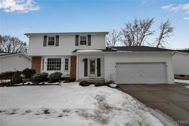 traditional-style home with a garage, concrete driveway, and brick siding