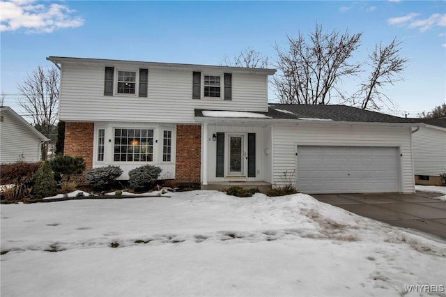 traditional home featuring driveway, brick siding, and an attached garage