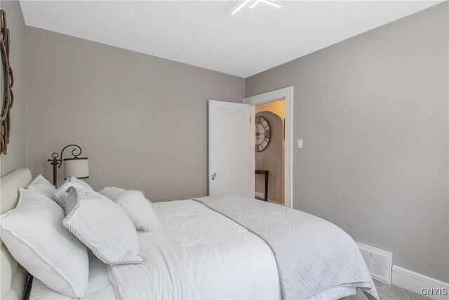 carpeted bedroom featuring visible vents and baseboards