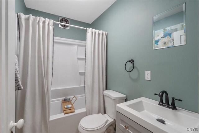 bathroom featuring shower / bath combination with curtain, vanity, and toilet