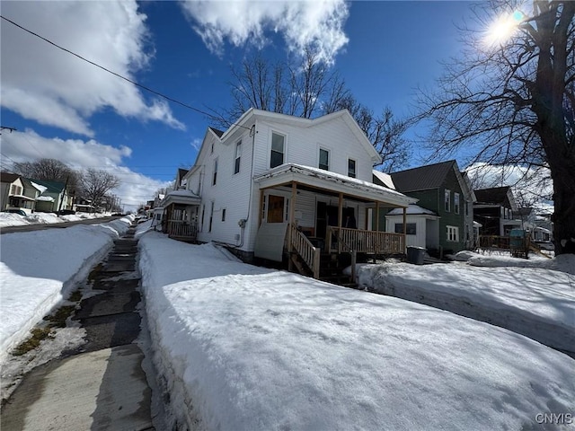 view of snow covered exterior with covered porch