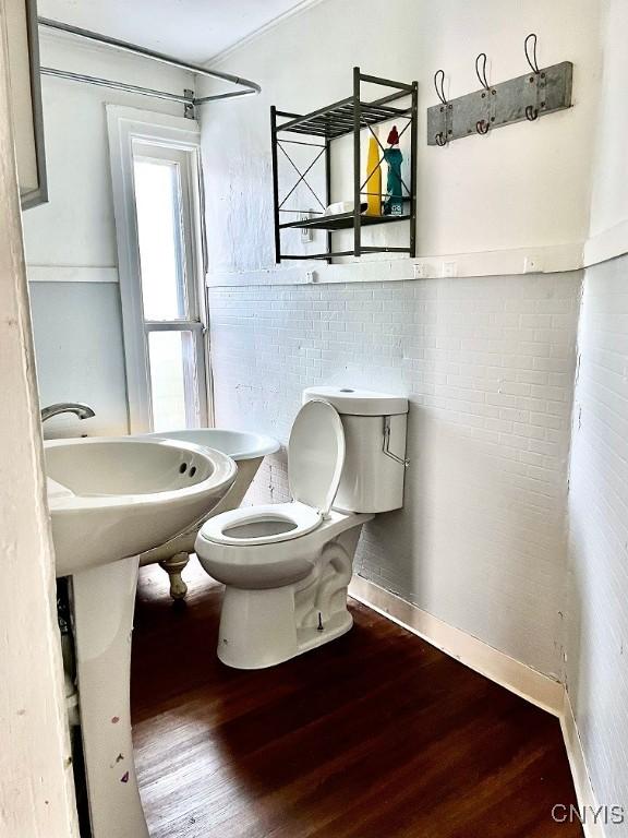 bathroom with toilet and wood finished floors