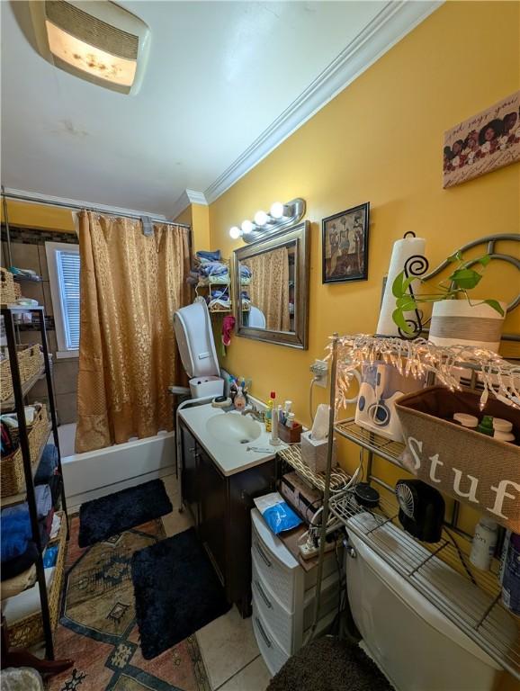 interior space with crown molding, tile patterned flooring, and a sink