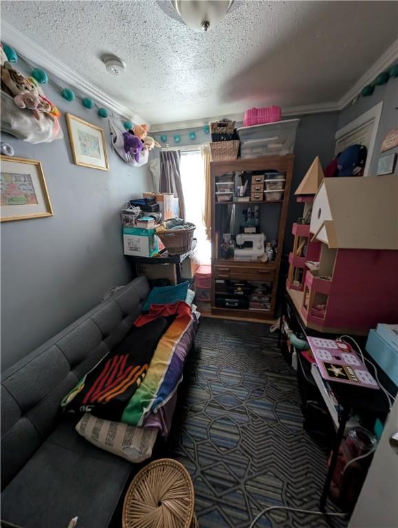 carpeted bedroom with crown molding and a textured ceiling