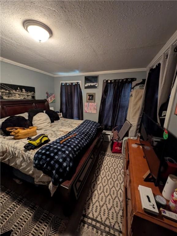 bedroom with a textured ceiling and ornamental molding